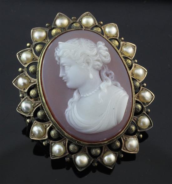 A Victorian gold and split pearl mounted hardstone cameo locket brooch, 1.75in.